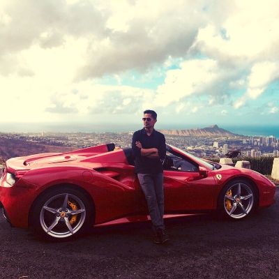 Daniella Deutscher husband, Jay Hernandez posing for a photoshoot while sitting on his red Ferrari model 488 Spider. 